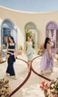 Three Aurelia looks — navy denim set with sash bows, mint butterfly-appliqué dress and lilac polka dot gown, in a courtyard of pastel archways