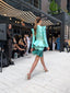 Verdant Poise — rear runway view of the tailored peplum